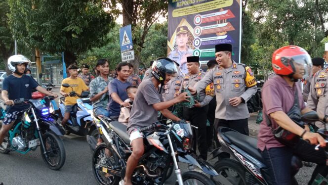 
					Kapolres Probolinggo AKBP Wisnu Wardana dan jajarannya serta Kepala Kejaksaan Negeri (Kejari) David. P Duarsa saat membagikan takjil ke para pengendara yang melintas. (Foto:Ist/Masfd)
